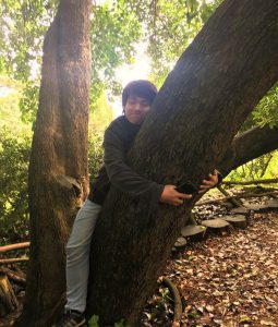 Loon happily hugs a tree