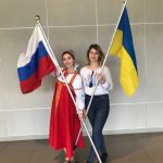 Elizaveta is pictured with another Global UGRAD participant from Ukraine, Helen. They are both holding their country flags.