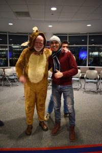 Firdavs is standing next to his advisor, Pat, who is wearing an animal Halloween costume.