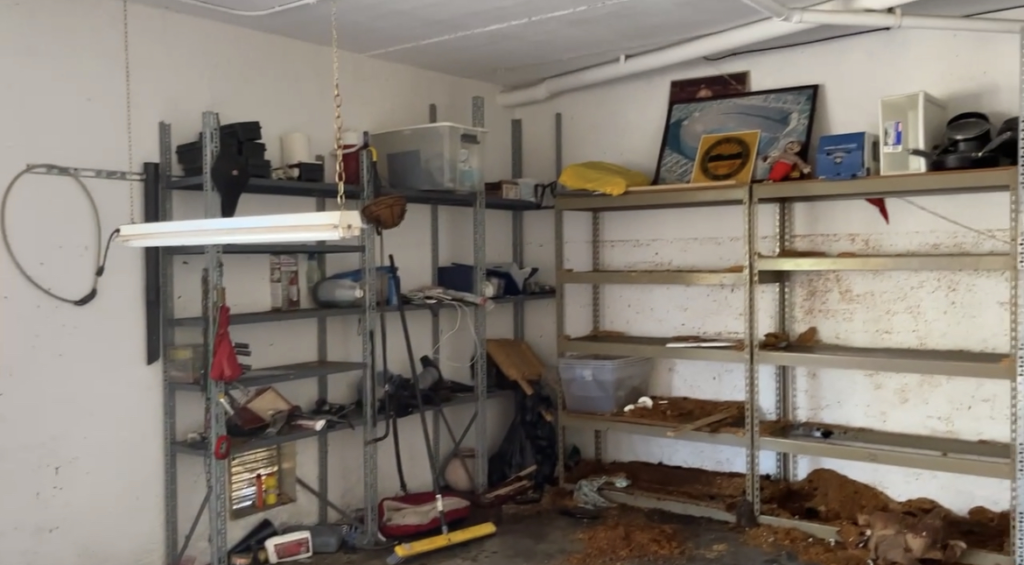 Garage marked with water line from flooding from Hurricane Ian