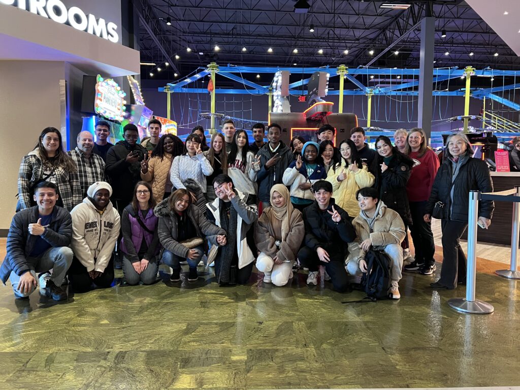 UCM International Students and Staff posing in arcade