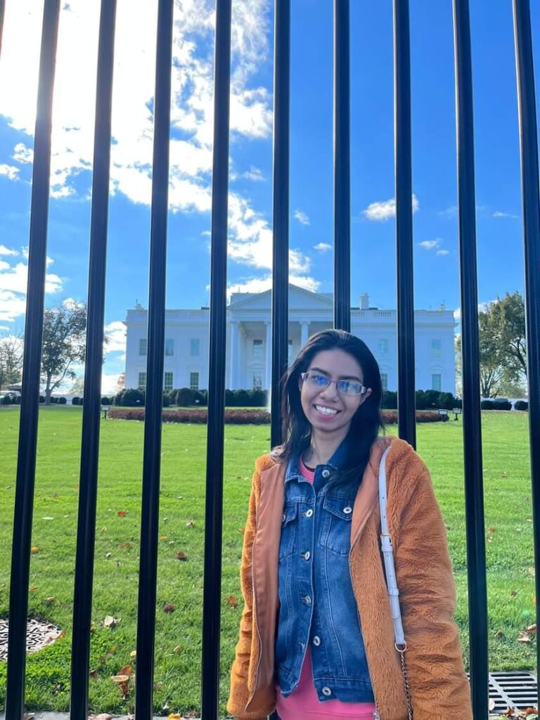 Hervinder posing with a smile in front of the White House on a sunny day during her visit to Washington DC 